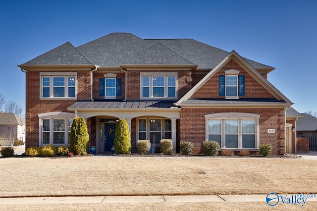 view of front of house with brick siding and a shingled roof