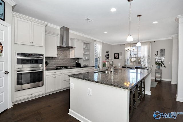 kitchen featuring a sink, crown molding, wall chimney exhaust hood, gas cooktop, and open shelves