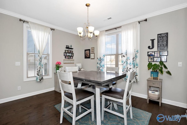 dining room featuring hardwood / wood-style floors, visible vents, a wealth of natural light, and ornamental molding