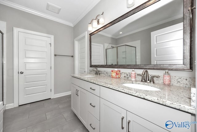 bathroom with a sink, a stall shower, double vanity, and ornamental molding