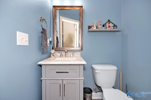 bathroom featuring vanity and toilet