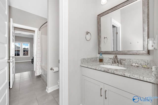 full bath featuring toilet, shower / tub combo, tile patterned flooring, baseboards, and vanity