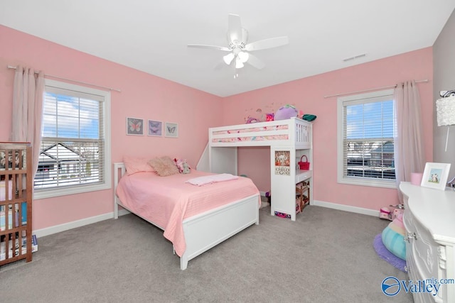 carpeted bedroom featuring visible vents, multiple windows, and baseboards