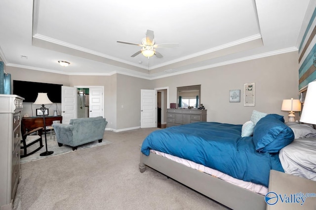 bedroom with a raised ceiling, crown molding, baseboards, and carpet floors