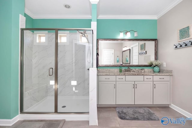 bathroom featuring baseboards, vanity, a shower stall, and crown molding