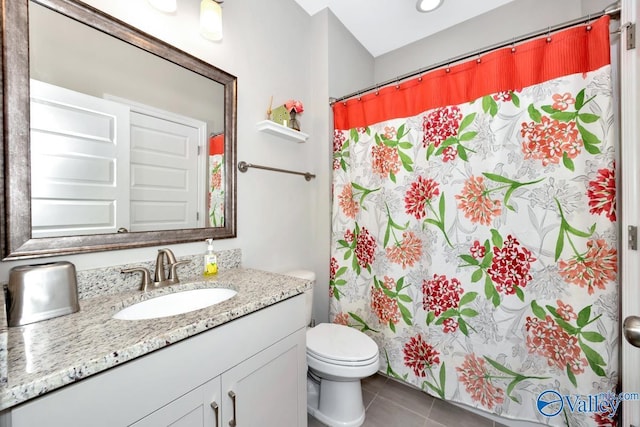 full bathroom with a shower with shower curtain, toilet, vanity, and tile patterned flooring