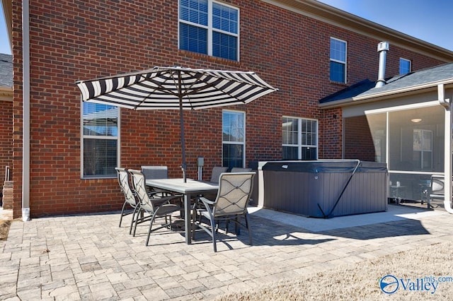 view of patio with outdoor dining space and a hot tub