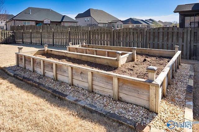 view of yard featuring a residential view, a vegetable garden, and fence