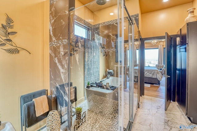 full bath with plenty of natural light, a shower stall, and marble finish floor