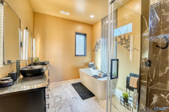 bathroom featuring marble finish floor, baseboards, visible vents, and a stall shower