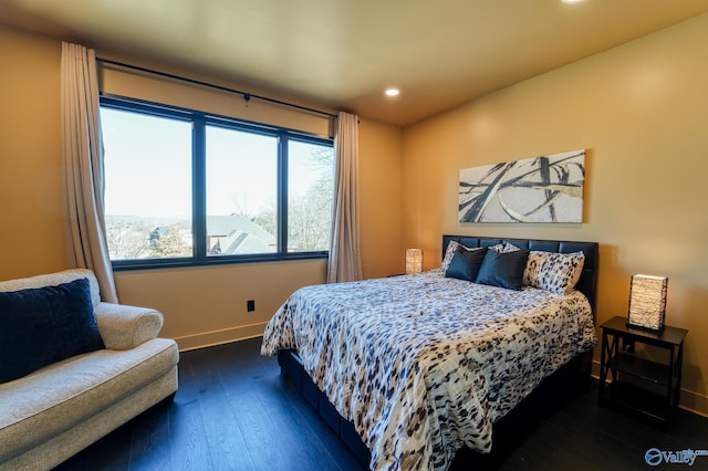 bedroom featuring dark wood-style floors, baseboards, and recessed lighting