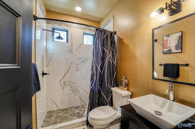 full bath featuring a stall shower, a sink, and toilet