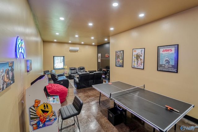 rec room featuring finished concrete flooring, a wall mounted air conditioner, and recessed lighting