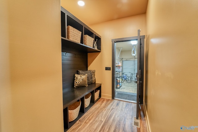 mudroom featuring recessed lighting, wood finished floors, and baseboards