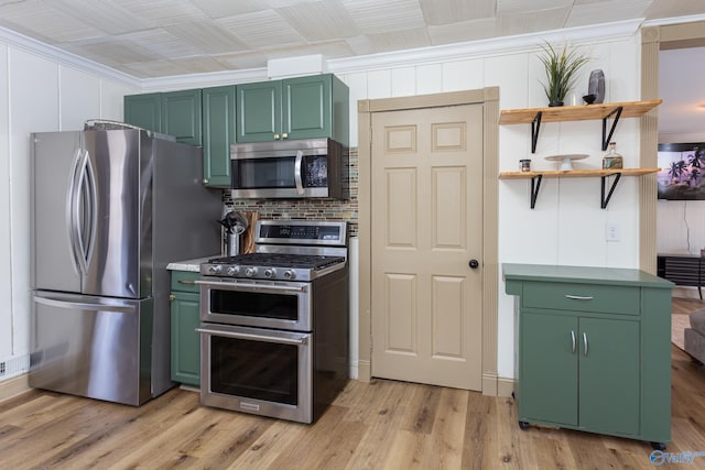 kitchen with decorative backsplash, appliances with stainless steel finishes, light wood-type flooring, open shelves, and green cabinetry