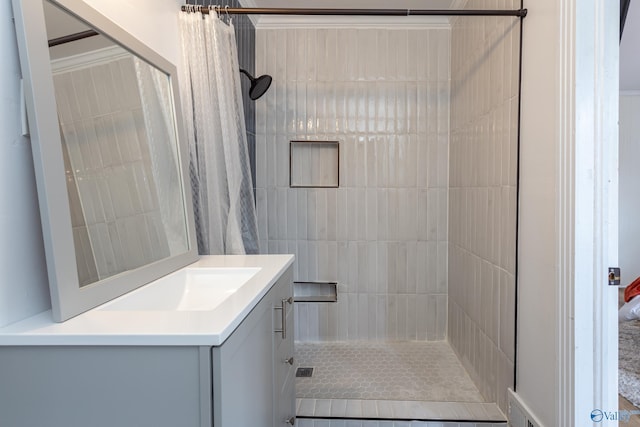 full bath with a shower stall and vanity