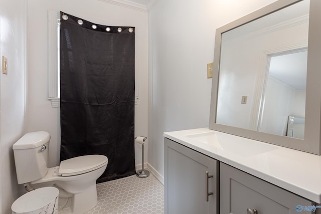 bathroom with baseboards, crown molding, vanity, and toilet