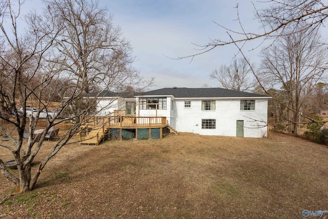 rear view of house featuring a yard and a wooden deck