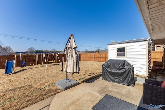 view of patio / terrace with a storage shed, a grill, and a playground