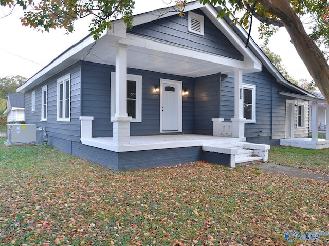 bungalow-style home with covered porch and cooling unit