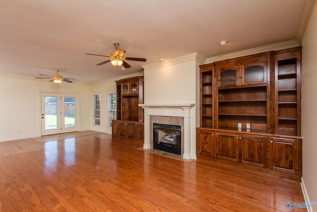 unfurnished living room featuring hardwood / wood-style floors, ceiling fan, and ornamental molding