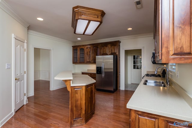 kitchen featuring a center island, wood-type flooring, stainless steel fridge with ice dispenser, and sink