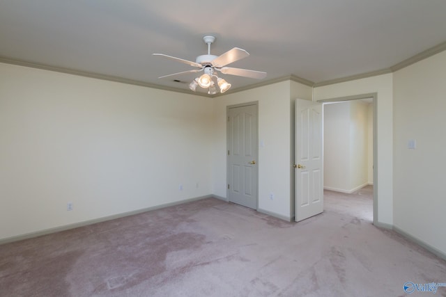 unfurnished bedroom with light colored carpet, ceiling fan, and crown molding