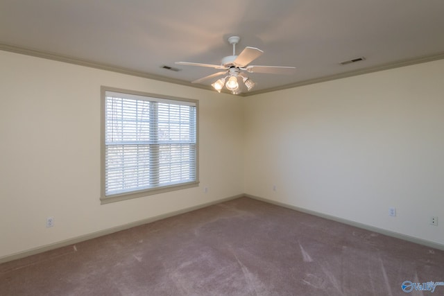 carpeted spare room featuring crown molding and ceiling fan