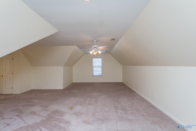 additional living space with light colored carpet, vaulted ceiling, and ceiling fan