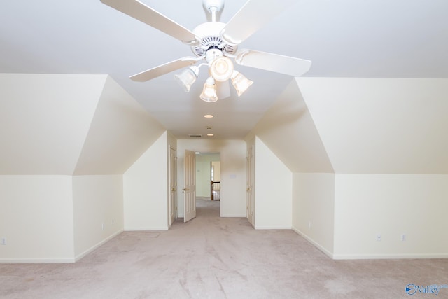 additional living space with ceiling fan, light carpet, and vaulted ceiling