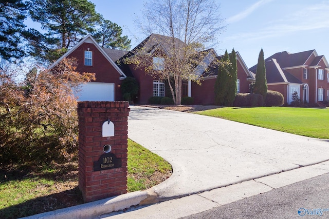 front of property with a front yard and a garage