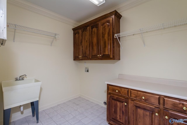 laundry room featuring washer hookup, light tile patterned flooring, cabinets, and crown molding