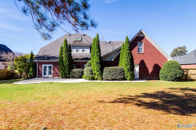 view of front facade with french doors, a front lawn, and a patio area