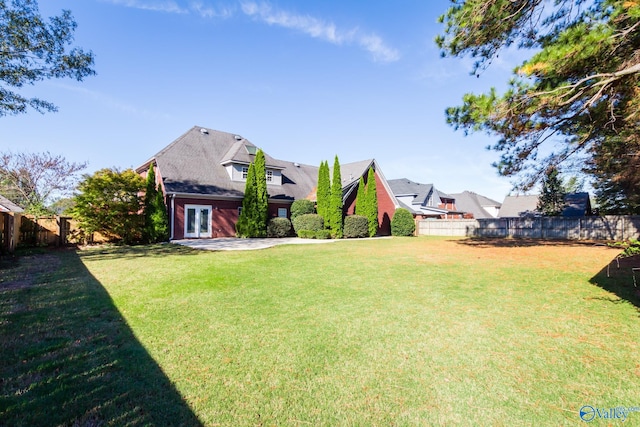 view of yard featuring french doors and a patio