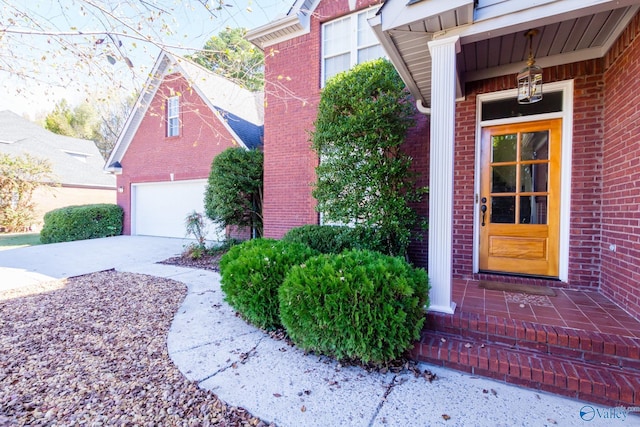 doorway to property with a garage