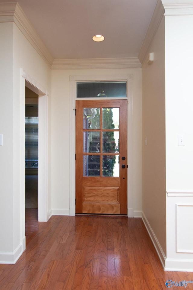 entryway featuring hardwood / wood-style floors and ornamental molding