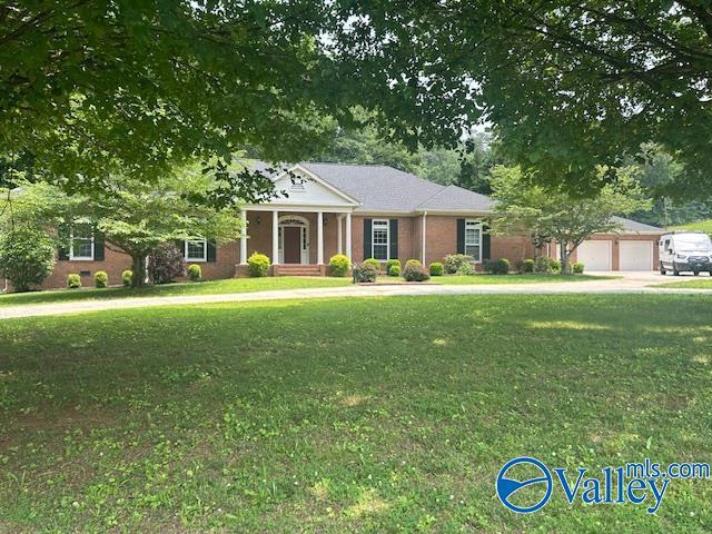 907 Buchannan St, Scottsboro, AL 35768 - greek revival inspired property featuring a front yard and an attached garage
