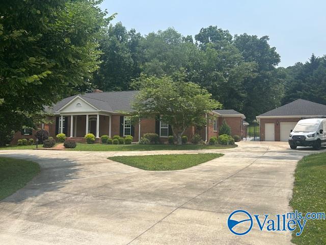 907 Buchannan St, Scottsboro, AL 35768 - view of front of house with a garage, driveway, and a front yard