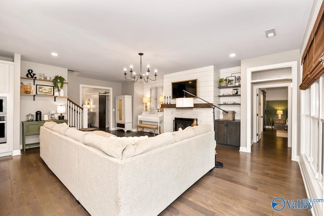 12 Cobbs Cove Way SE, Huntsville, AL 35803 - living room featuring dark wood-type flooring, recessed lighting, a chandelier, a stone fireplace, and stairway