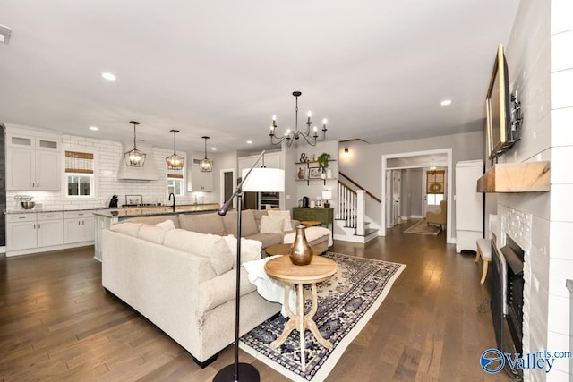 12 Cobbs Cove Way SE, Huntsville, AL 35803 - living room featuring a fireplace, dark wood finished floors, recessed lighting, stairway, and a chandelier