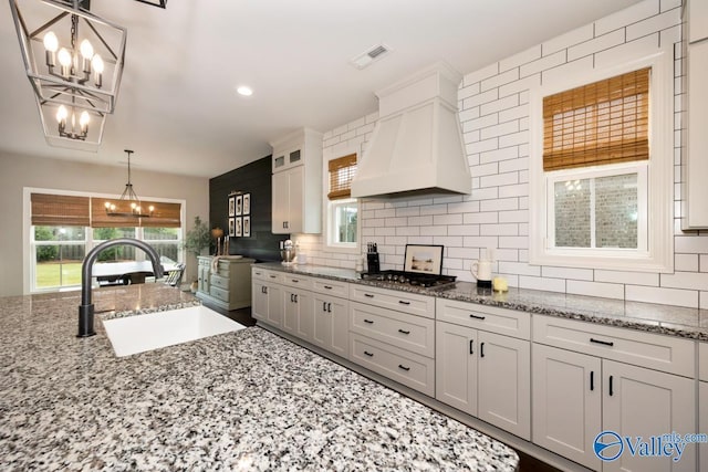 12 Cobbs Cove Way SE, Huntsville, AL 35803 - kitchen with a chandelier, premium range hood, a sink, decorative backsplash, and recessed lighting