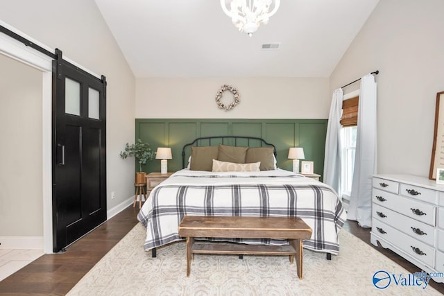 12 Cobbs Cove Way SE, Huntsville, AL 35803 - bedroom featuring lofted ceiling, a chandelier, a barn door, and baseboards