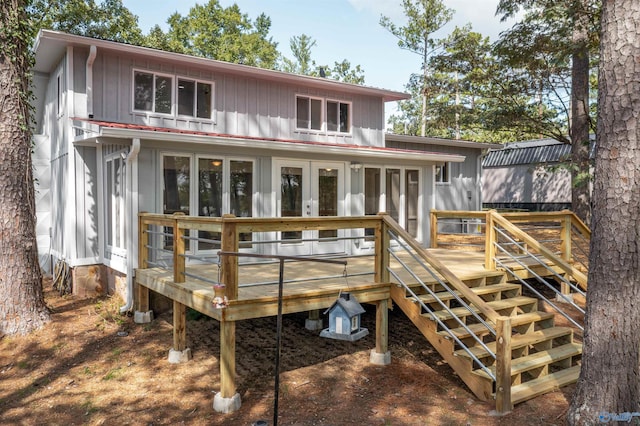 rear view of property featuring stairs, french doors, and a wooden deck