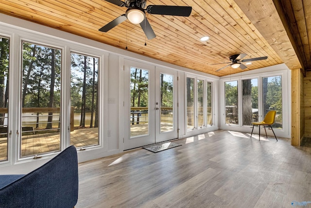 unfurnished sunroom featuring a wealth of natural light, french doors, wood finished floors, and wooden ceiling