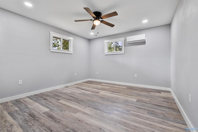 unfurnished room with recessed lighting, an AC wall unit, a ceiling fan, and plenty of natural light