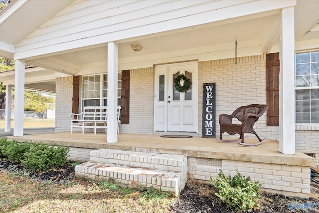 view of exterior entry featuring a porch