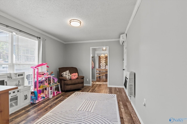 rec room with sink, crown molding, dark wood-type flooring, heating unit, and a textured ceiling