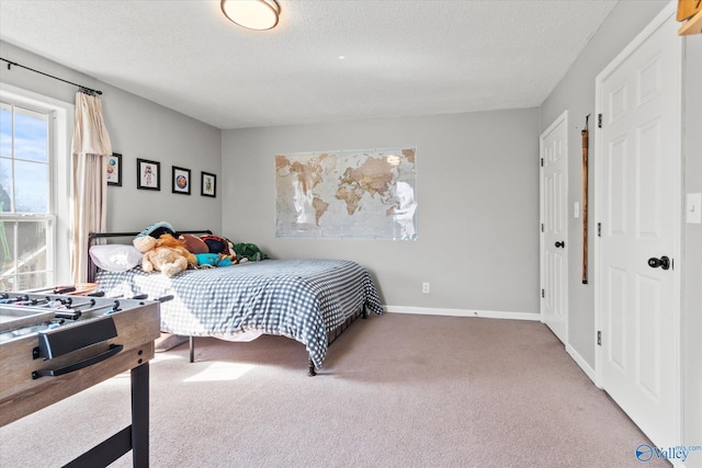 bedroom featuring carpet and a textured ceiling