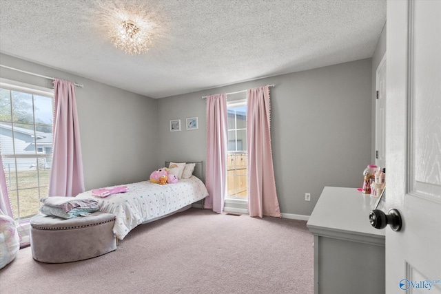 carpeted bedroom with a textured ceiling