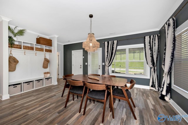 dining space with baseboards, wood finished floors, and ornamental molding